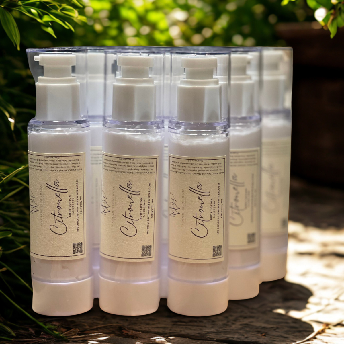 Upclose image of Citronella bottles filled with lotion in a garden on a gray brick