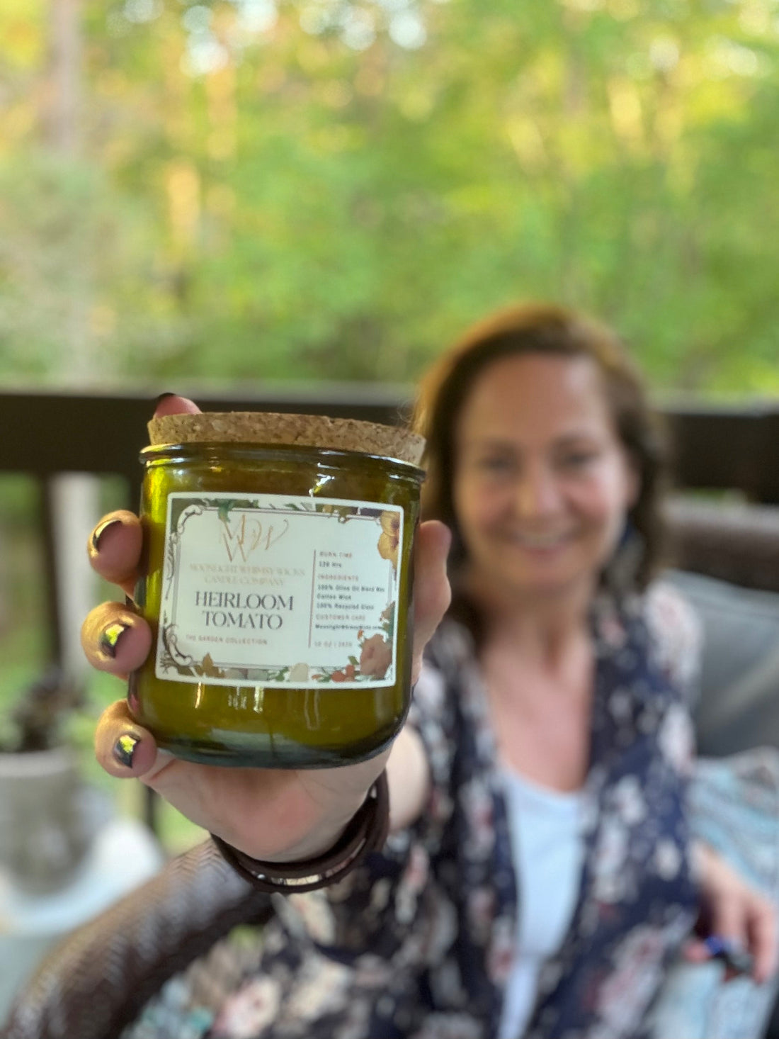 Up close image of an Heirloom Tomato Candle from Moonlight Whimsy Wicks with Erin holding it.