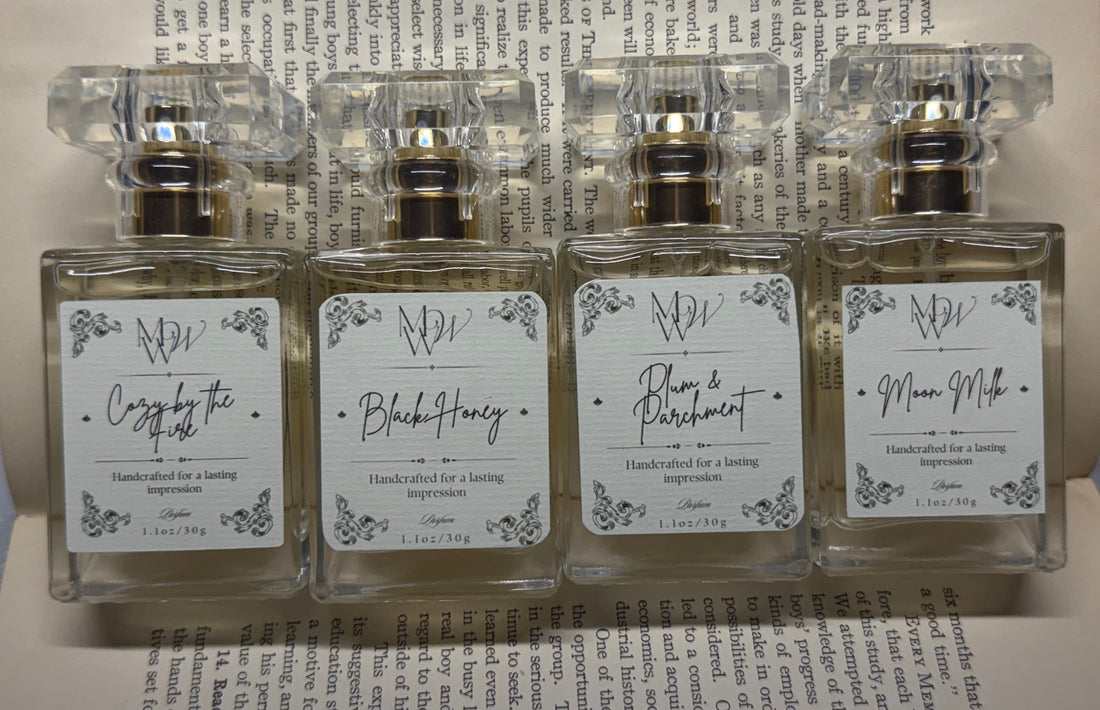 Moonlight Whimsy Wicks Cozy by the Fire, Black Honey, Plum & Parchment, and Moon Milk fall perfumes displayed on open book pages.