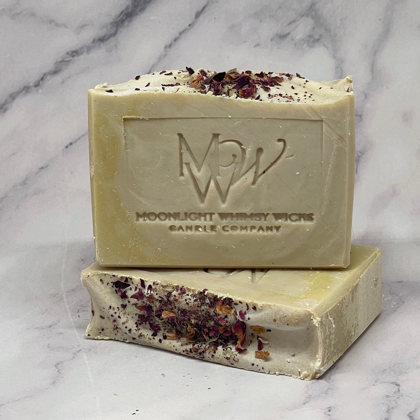 Bar of soap with a visible brand logo on a marble surface