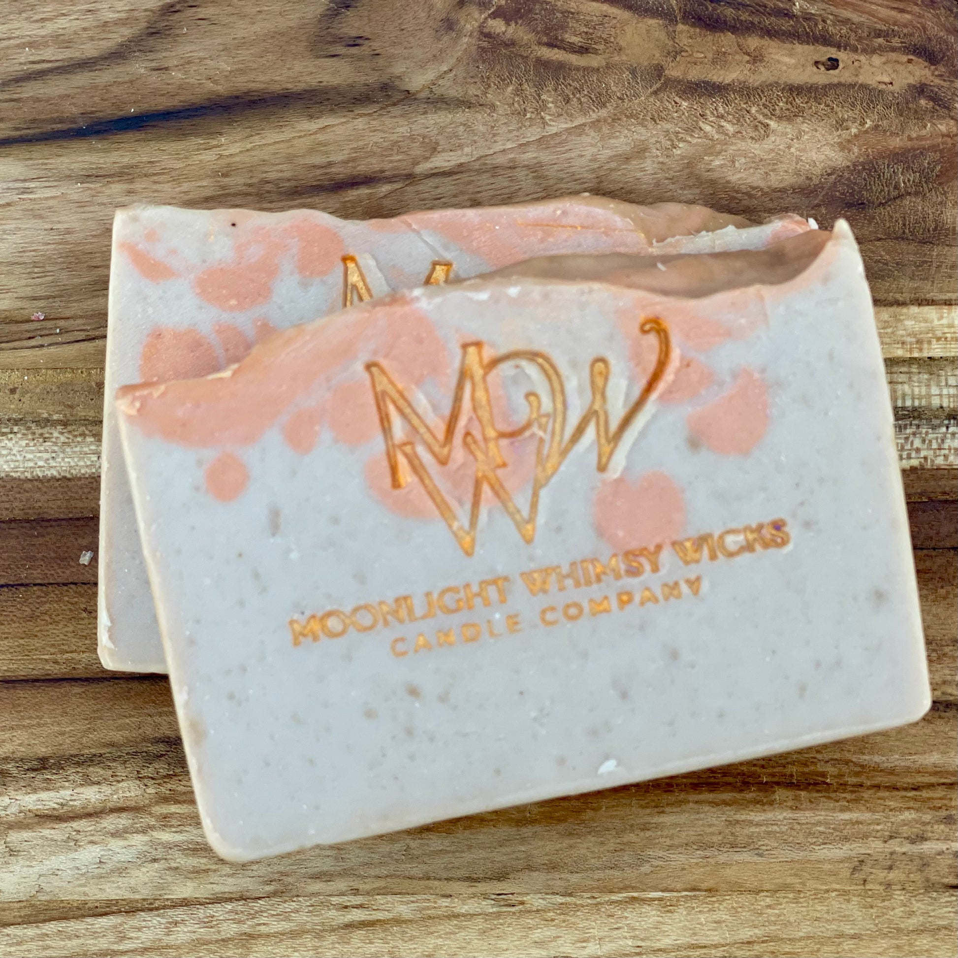 Moonlight Whimsy Wicks handmade artisan soap bar with warm orange swirls and gold foil logo, crafted using the cold process method. Small batch natural soap with a soft citrus scent and gentle exfoliating texture, ideal for daily skincare.  Inspired by Bitter Peach.