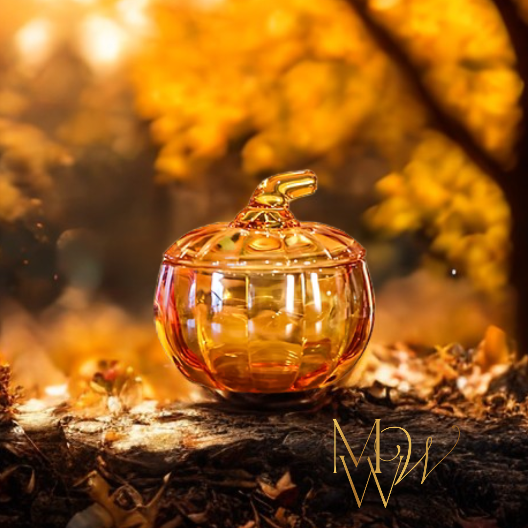 Glass pumpkin candle with a lid on a tree stump in an autumn setting