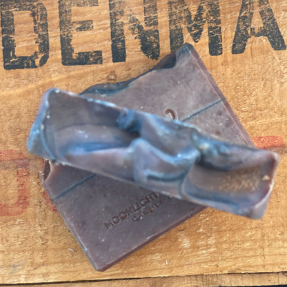 Handmade Cocoa Butter & Coconut soap bar by Moonlight Whimsy Wicks, featuring a layered design in warm earthy tones with the MWW logo stamped on top, set on a rustic wooden background.