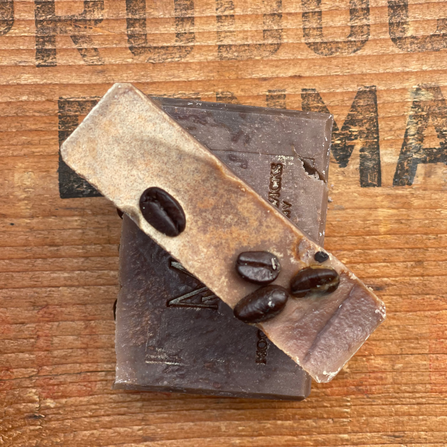 Handmade Coffee soap bar by Moonlight Whimsy Wicks, featuring warm earthy tones with the MWW logo stamped on top, set on a rustic wooden background.