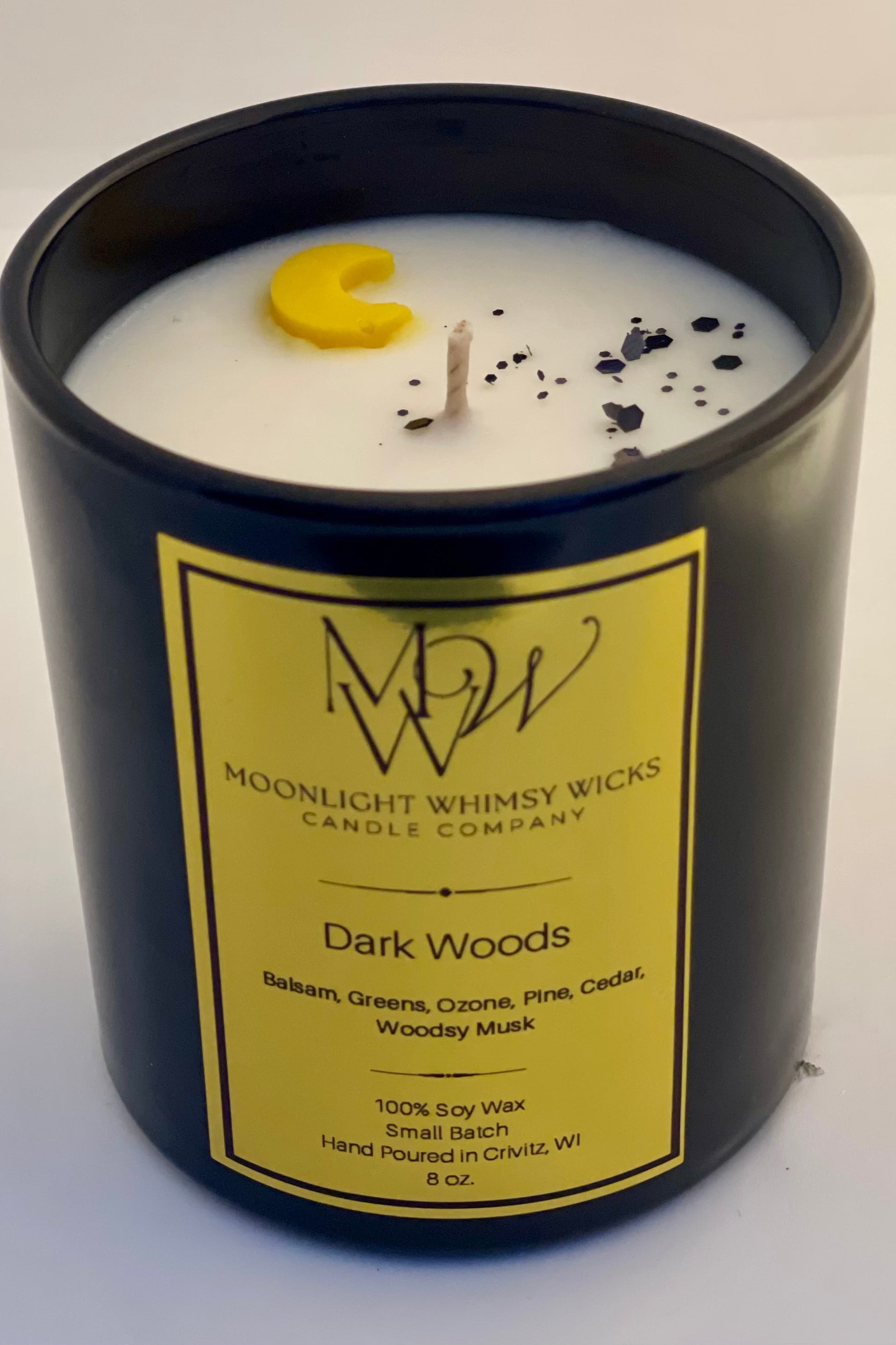 An  8 oz. Moonlight Whimsy Wicks Candle in the fragrance Dark Woods