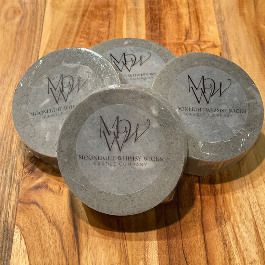 Handcrafted round goat's milk soap bar on an elegant wooden cutting board, showcasing its premium quality and organic ingredients for a luxurious skincare experience.