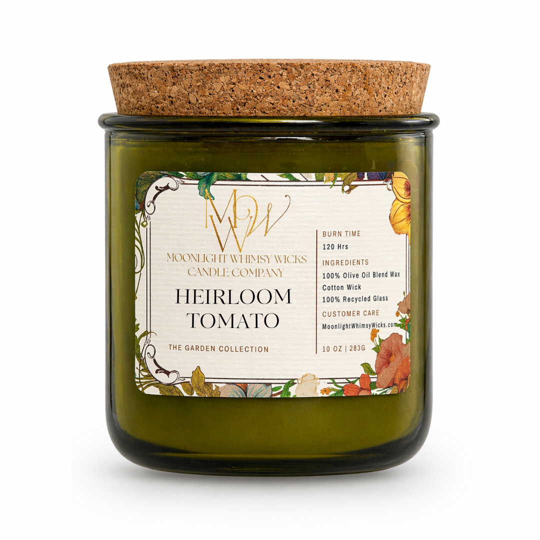 Heirloom Tomato Candle from The Garden Collection by Moonlight Whimsy Wicks. Hand-poured in a recycled green glass jar with a cork lid, this olive oil wax candle features a botanical label and sits among fresh vine-ripened tomatoes and lush green leaves. Perfect for garden lovers and eco-friendly candle enthusiasts seeking a fresh, earthy scent.
