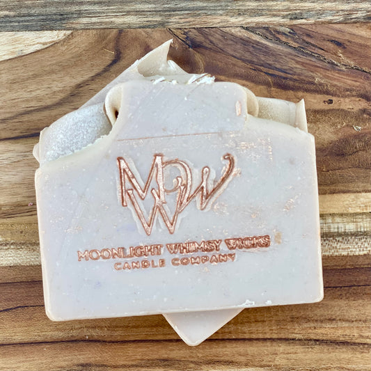 Moonlight Whimsy Wicks handmade Oatmeal Milk & Honey cold process soap bar, embossed with a copper foil logo. Small batch artisan soap made with nourishing oils, oatmeal, and a warm comforting scent for dry and sensitive skin.