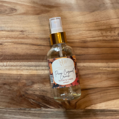 Pecan Caramel Crunch Room & Linen spray  by Moonlight Whimsy Wicks with a label on a wooden surface