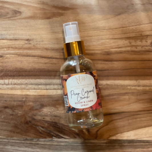 Pecan Caramel Crunch Room & Linen spray  by Moonlight Whimsy Wicks with a label on a wooden surface