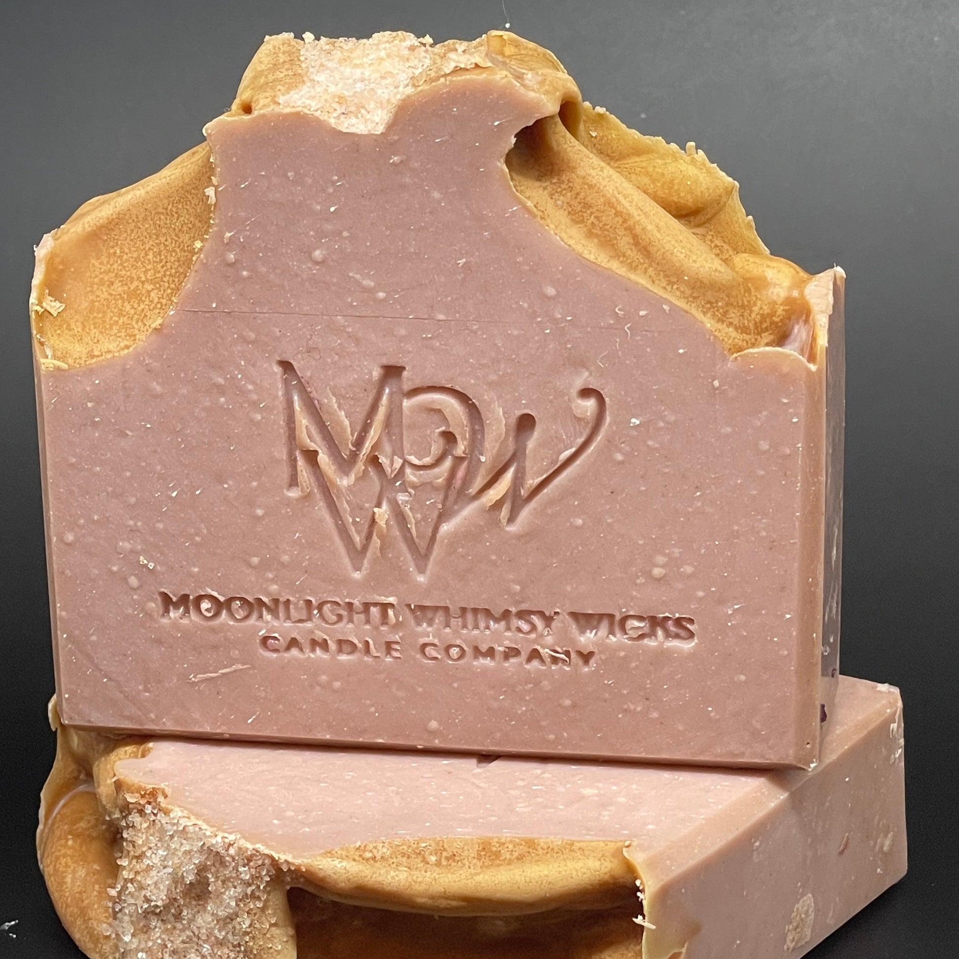 Bar of soap with 'MW' branding on a dark background