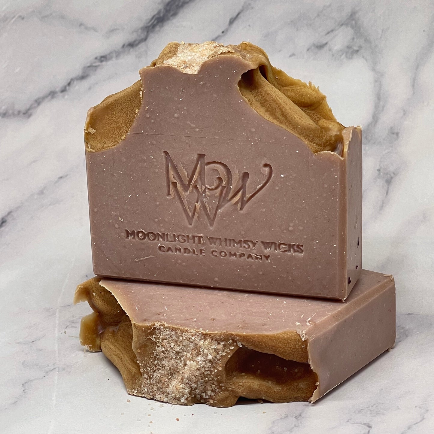 Soap bar with a visible brand logo on a marble surface