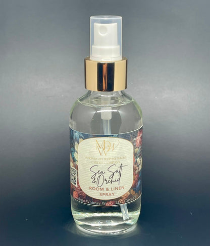 Clear spray bottle with a label on a gray background Sea Salt & Orchid Room & Linen Spray by Moonlight WHimsy Wicks