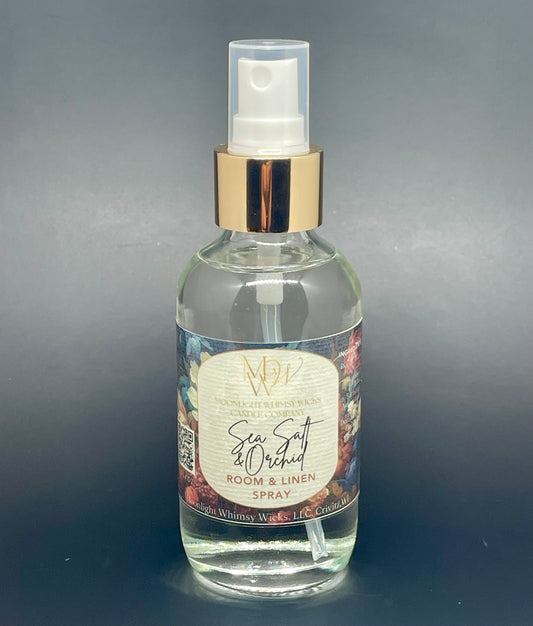 Clear spray bottle with a label on a gray background Sea Salt & Orchid Room & Linen Spray by Moonlight WHimsy Wicks