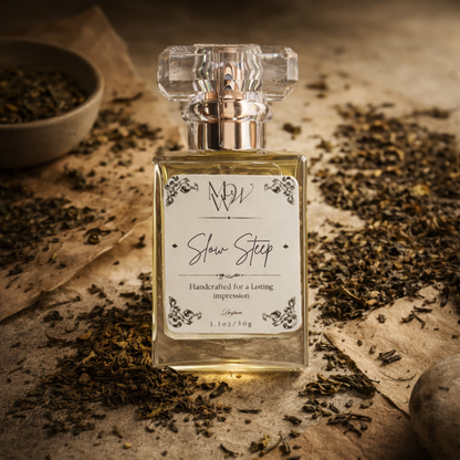 Perfume bottle labeled 'Slow Step' surrounded by dried leaves on a textured surface